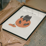 Black Cat Playfully Sitting In A Pumpkin